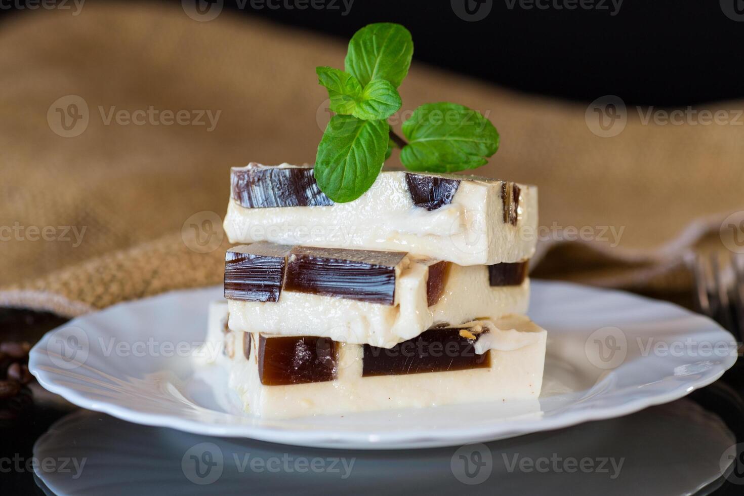 Delicious dessert. coffee jelly pieces inside white milk jelly photo