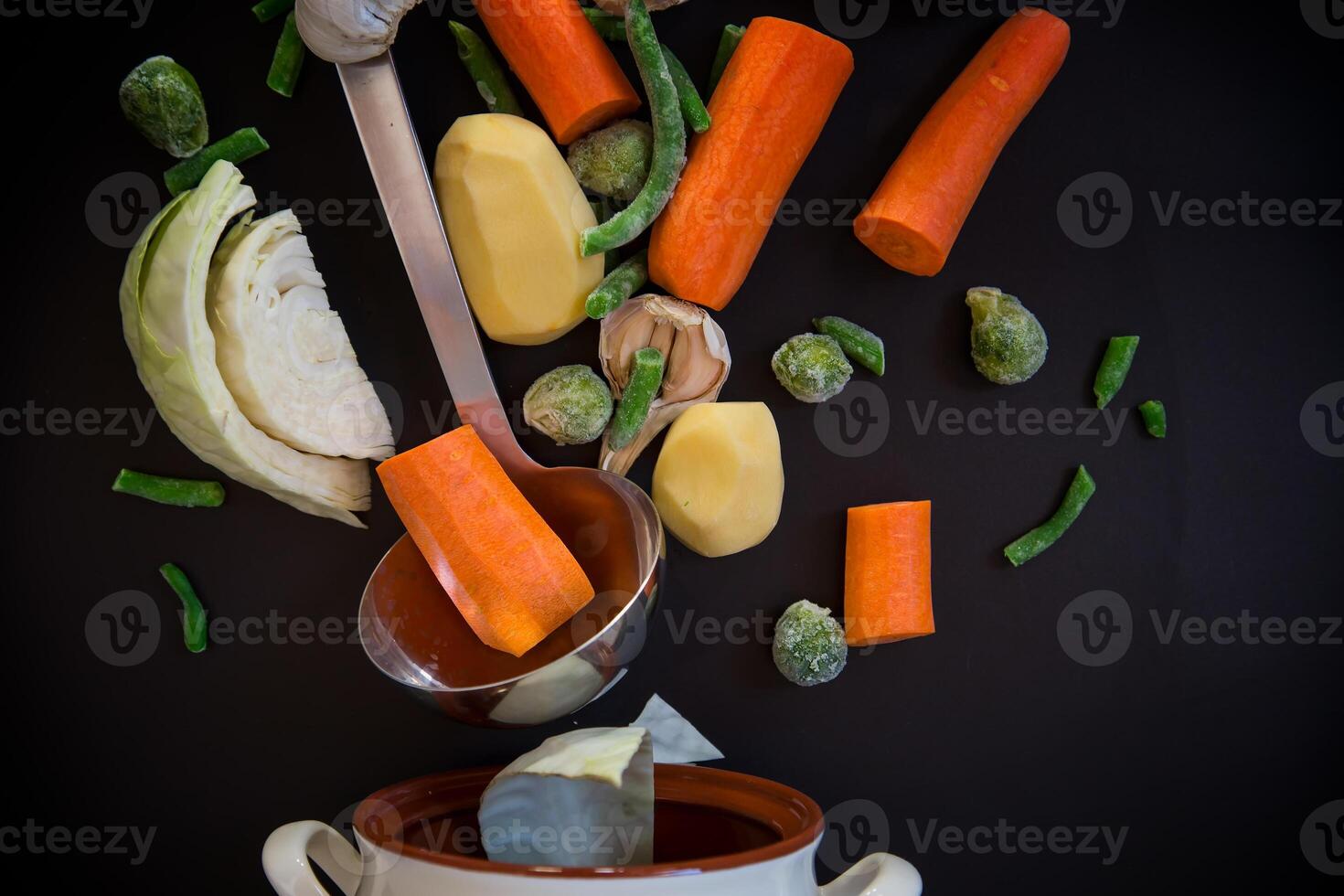 Vegetables in motion before cooking in soup photo