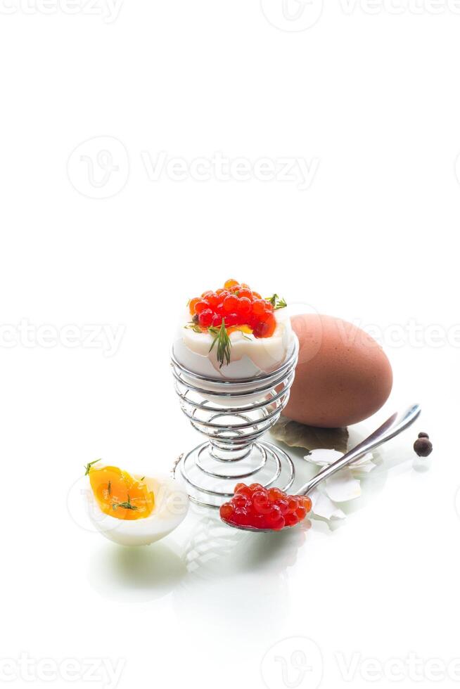 delicacy with red caviar and boiled egg for breakfast, isolated on white background photo