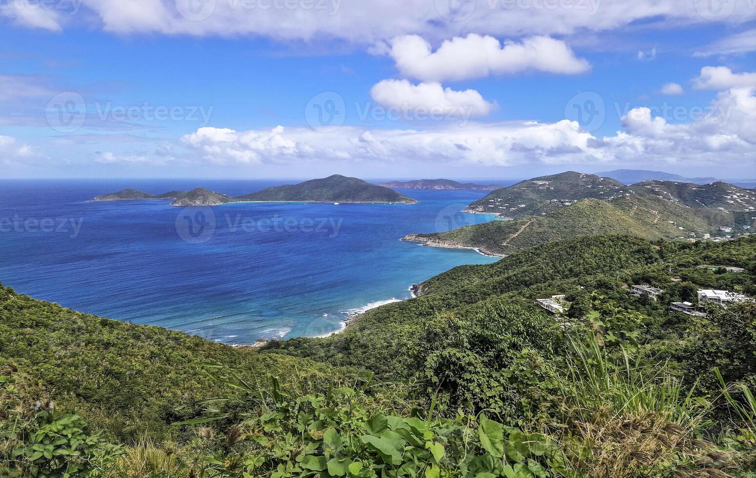 Tropical Caribbean landscape with lush green hills and blue ocean views photo