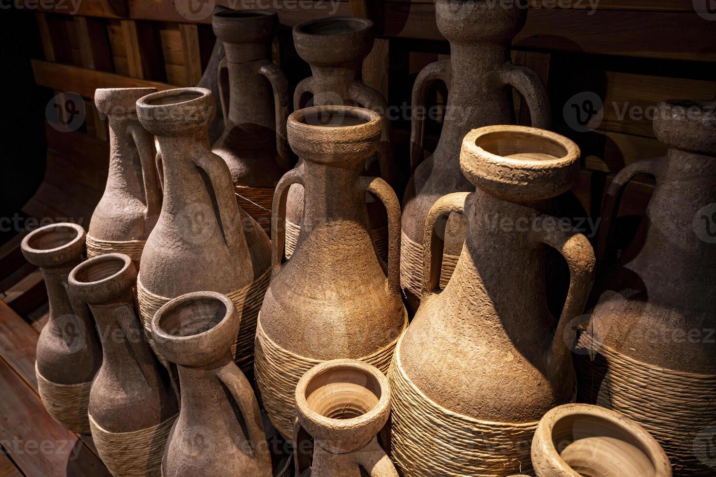 Ancient Etruscan Amphorae with Rope Wrapping in Rustic Museum photo