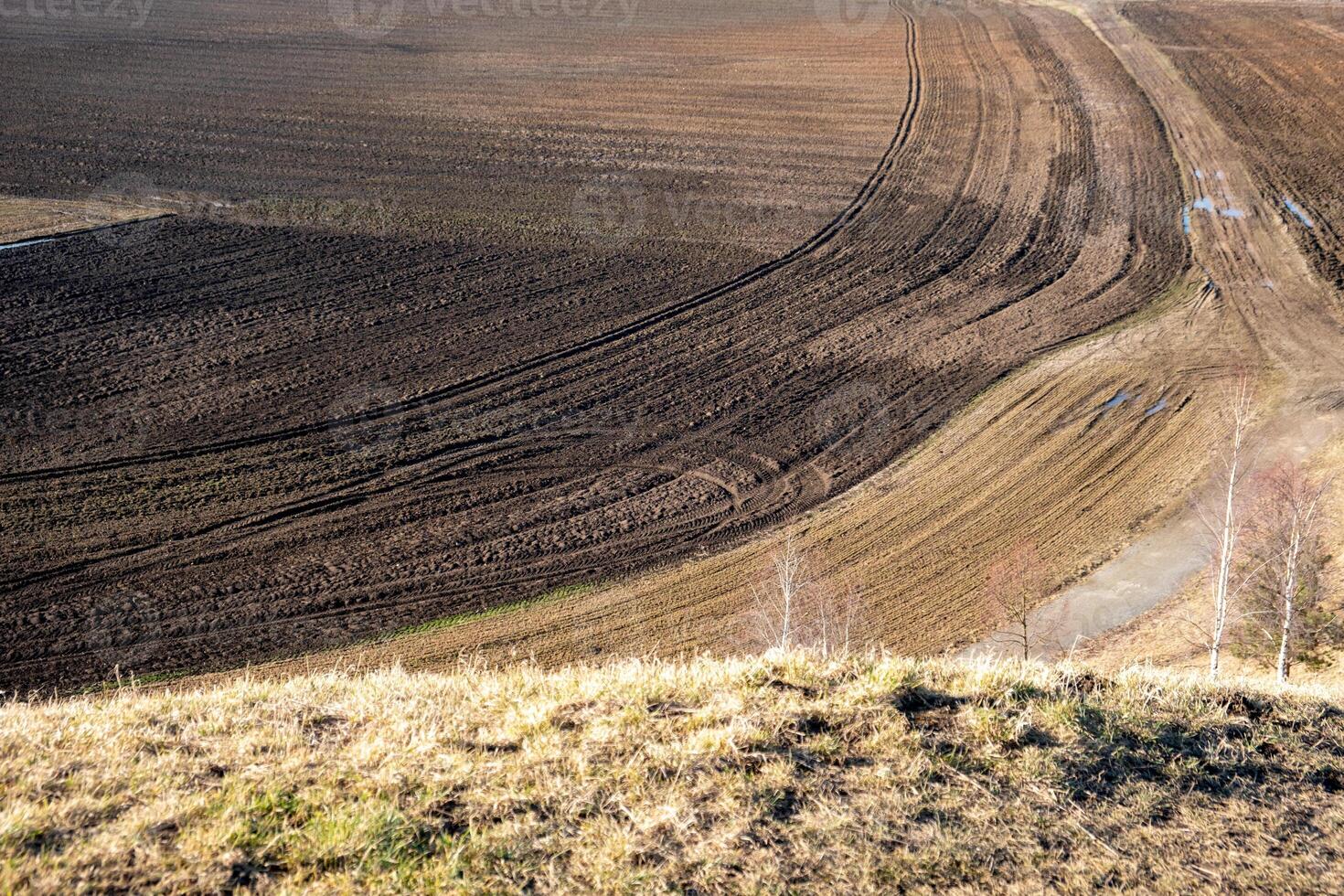 Open countryside with cultivated fields, early springtime farming scene photo