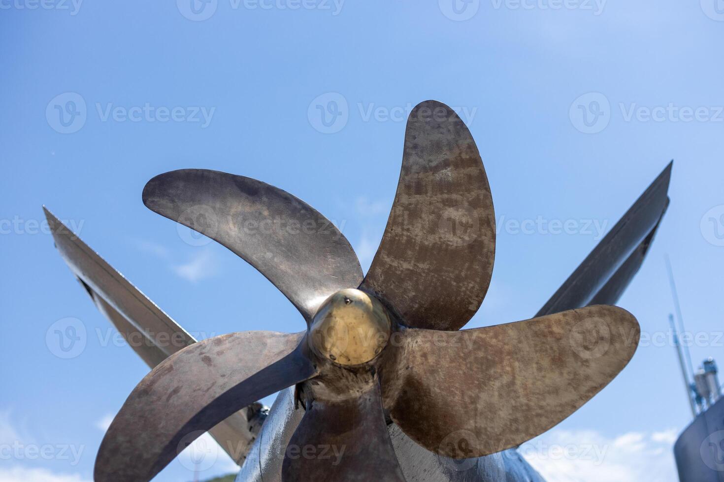 Boat propeller against the background of a blue sky near a sunny day. photo