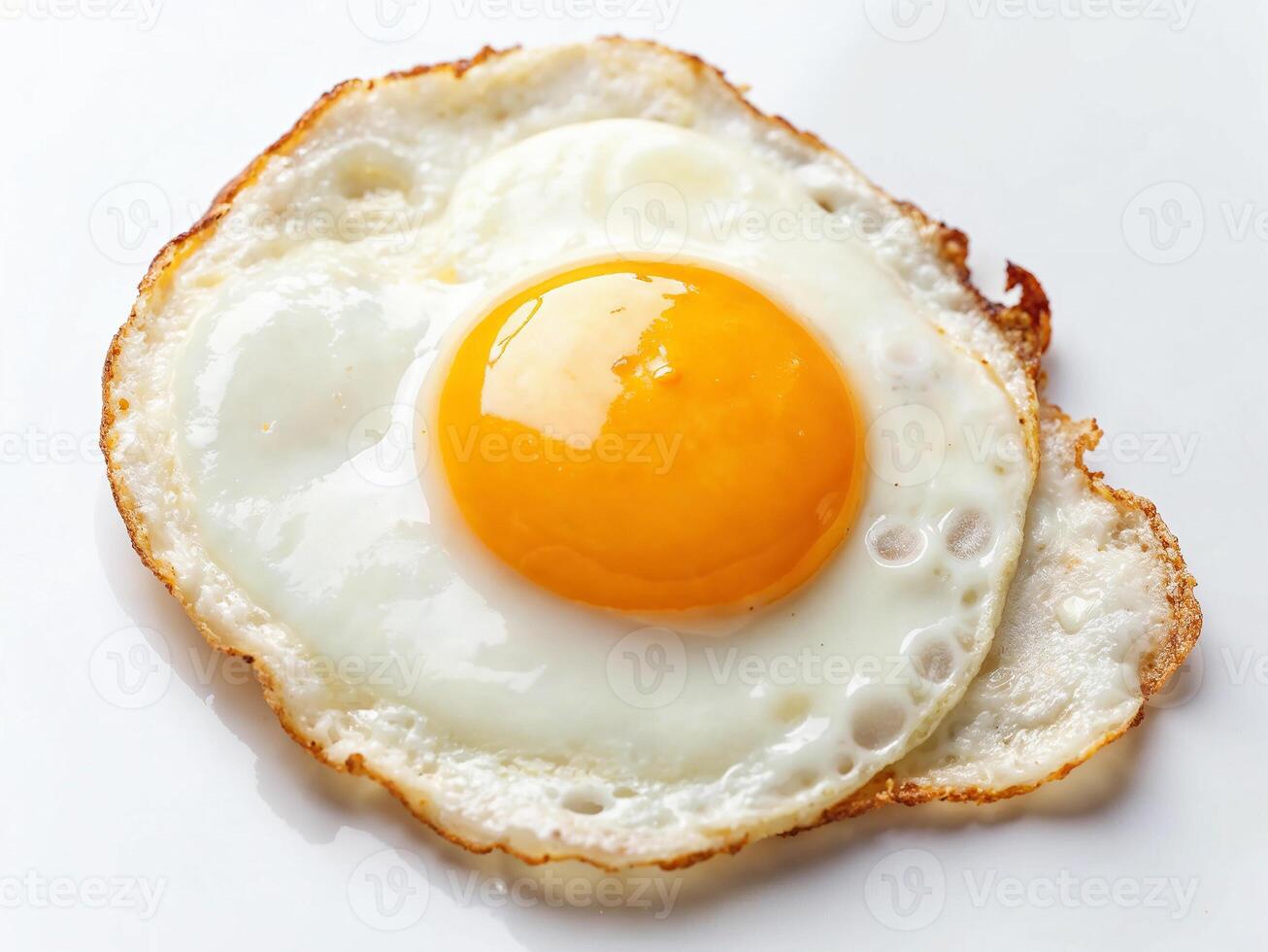Fried egg with bright yolk served on a clean white plate in a kitchen setting photo