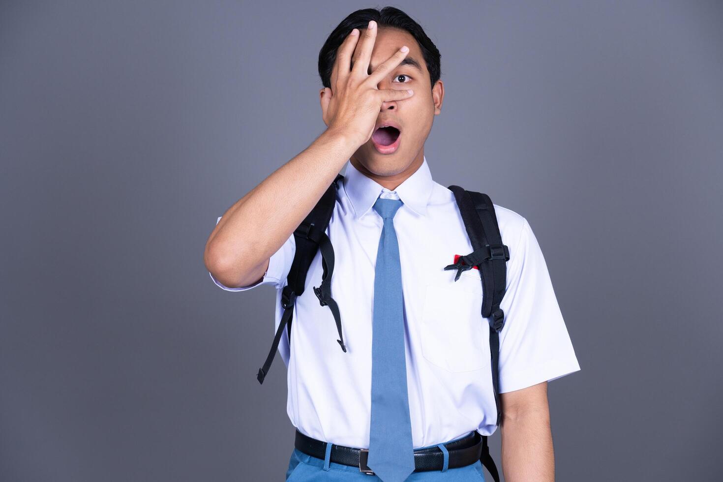 Indonesian Male High School Students in Uniforms Surprised Background photo