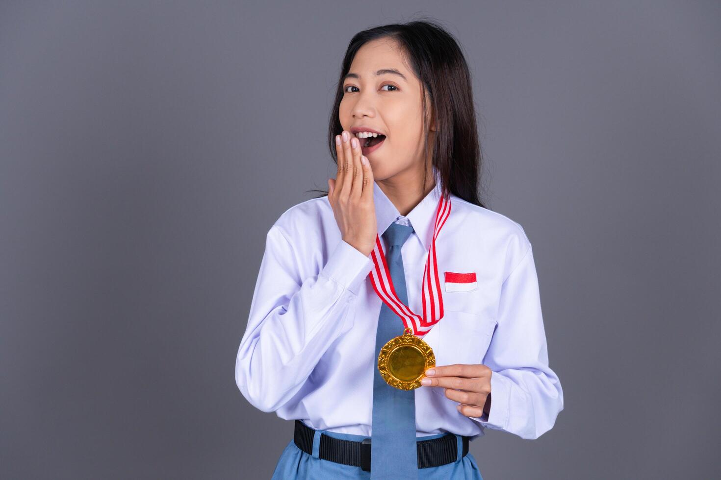 Indonesian Female High School in Uniform Student Achieves Gold Medal Background photo