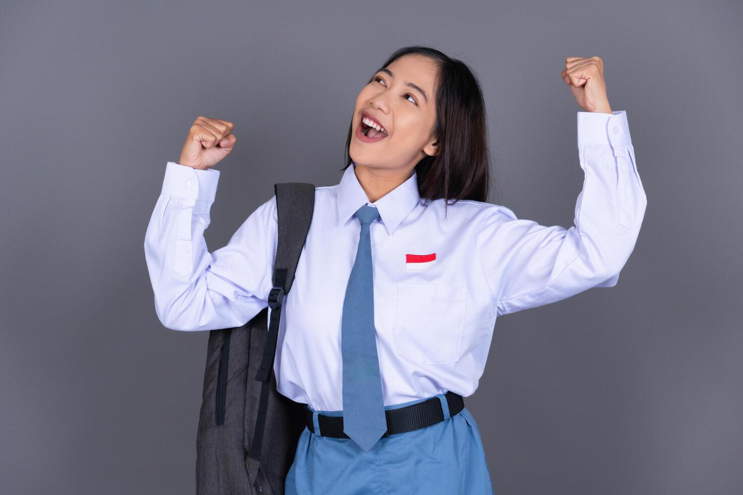 Indonesian Girl High School Student in Uniform Gesture Celebrating photo