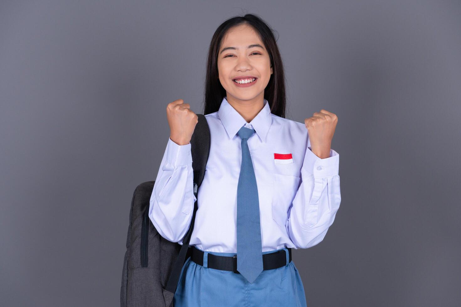 Indonesian Female High School Student in Uniform Gesture Celebrating photo