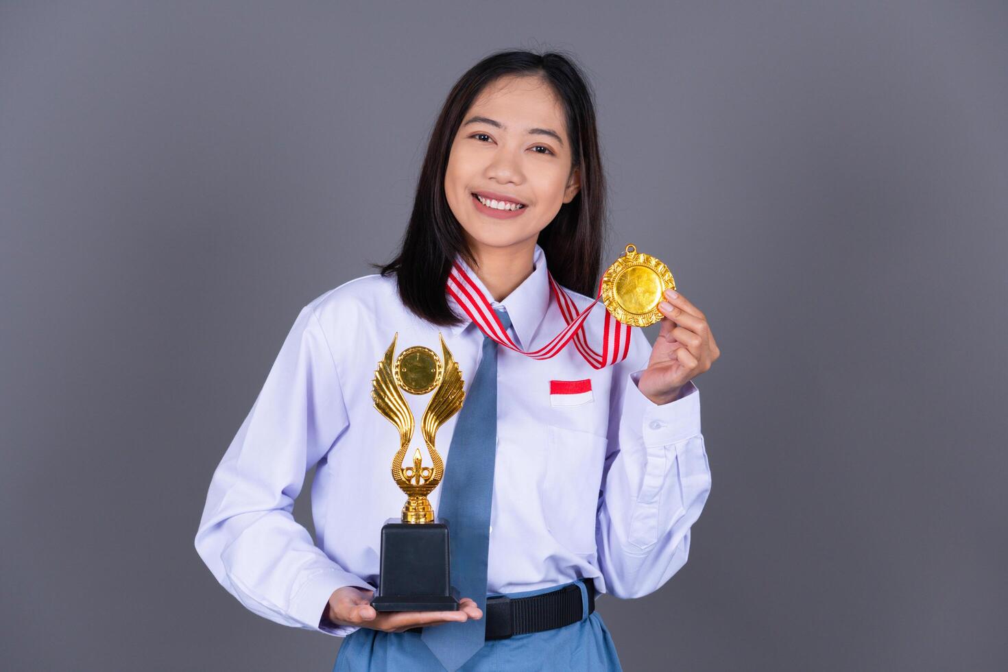 Indonesian Female High School in Uniform Student Achieves Gold Medal photo