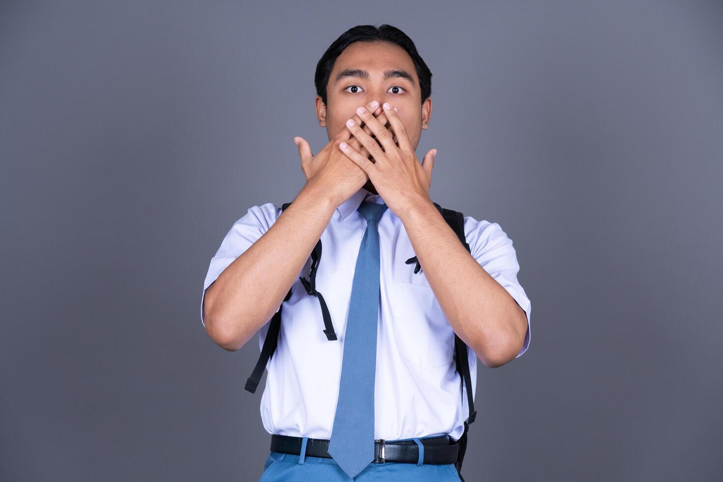 Indonesian Male High School Students in Uniforms Surprised Isolated Background photo