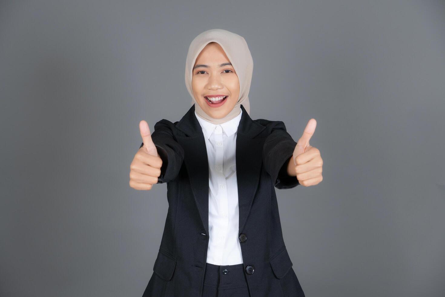Portrait of Young Confident Girl in a Hijab Thumbs Up in Approval or Recommendation photo