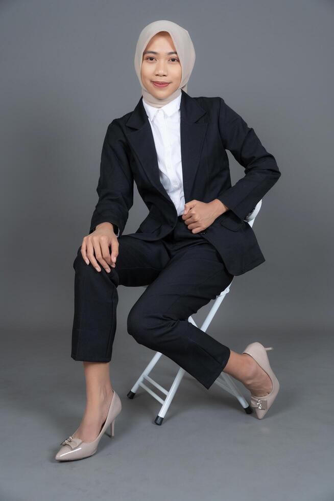 Full Body Portrait of Young Female in a Hijab Posing with Chair Background photo