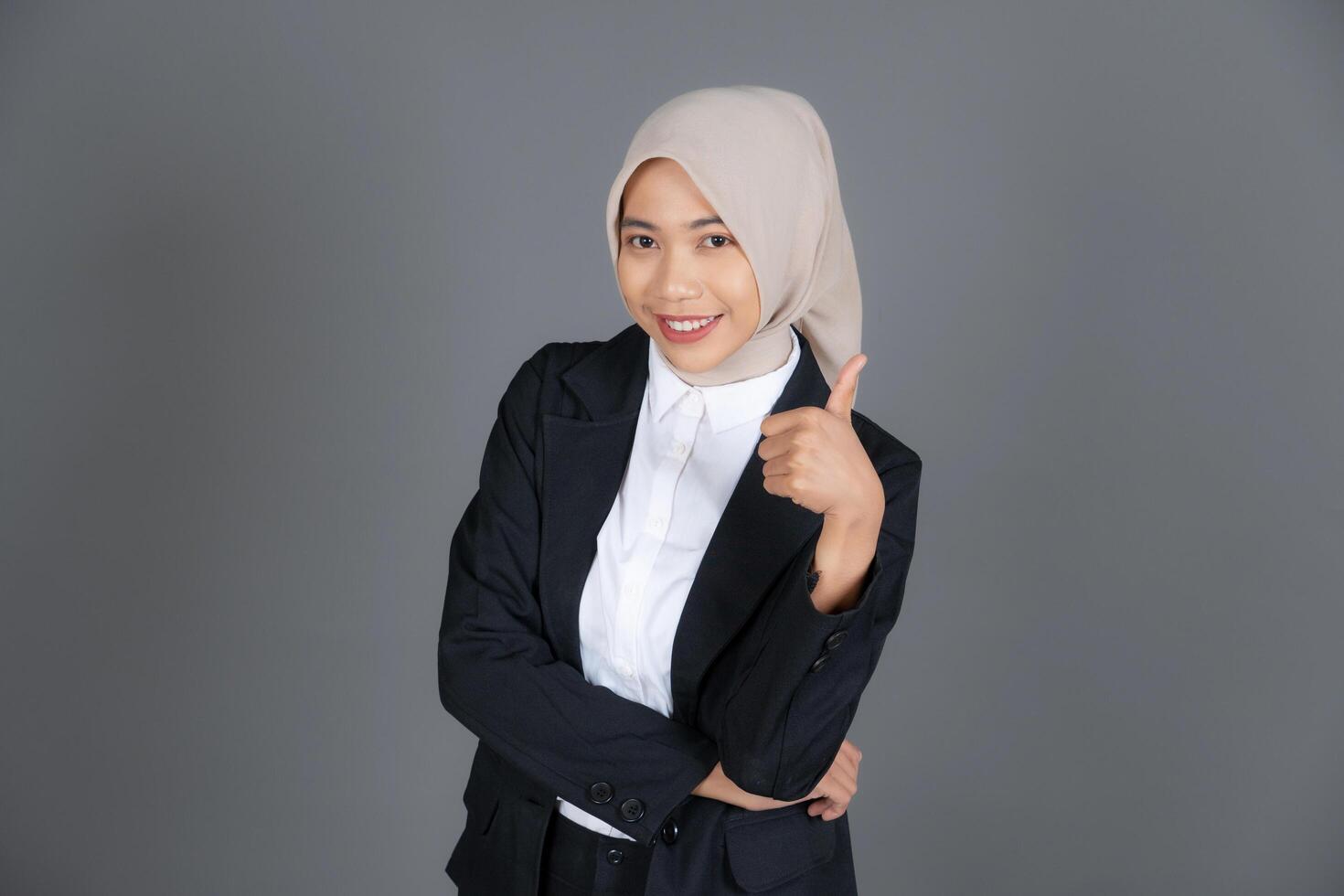 Portrait of Young Confident Female in a Hijab Thumbs Up in Approval or Recommendation photo