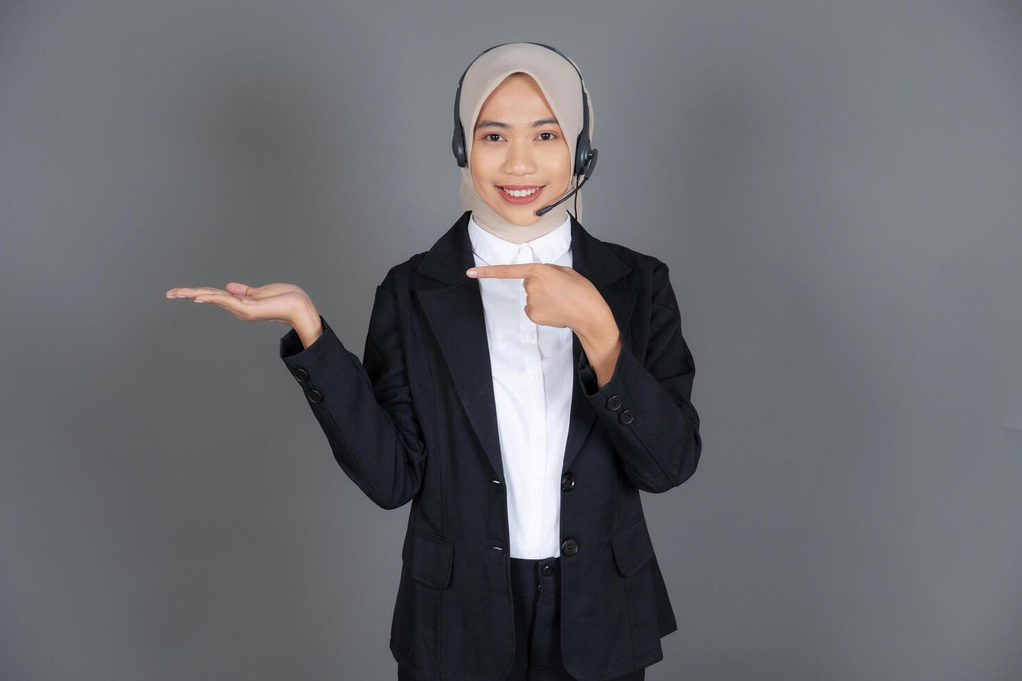 Young Woman Customer Service Representative Agent in a Hijab Presenting or Explaining photo