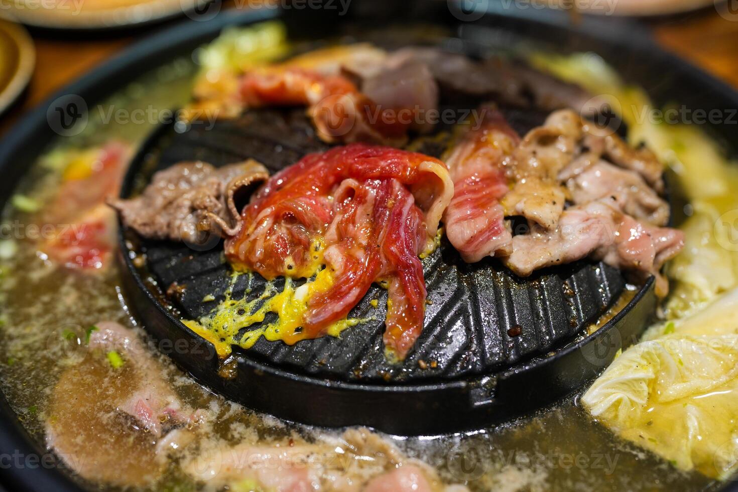 Grilled pork and beef on electronic stove. photo