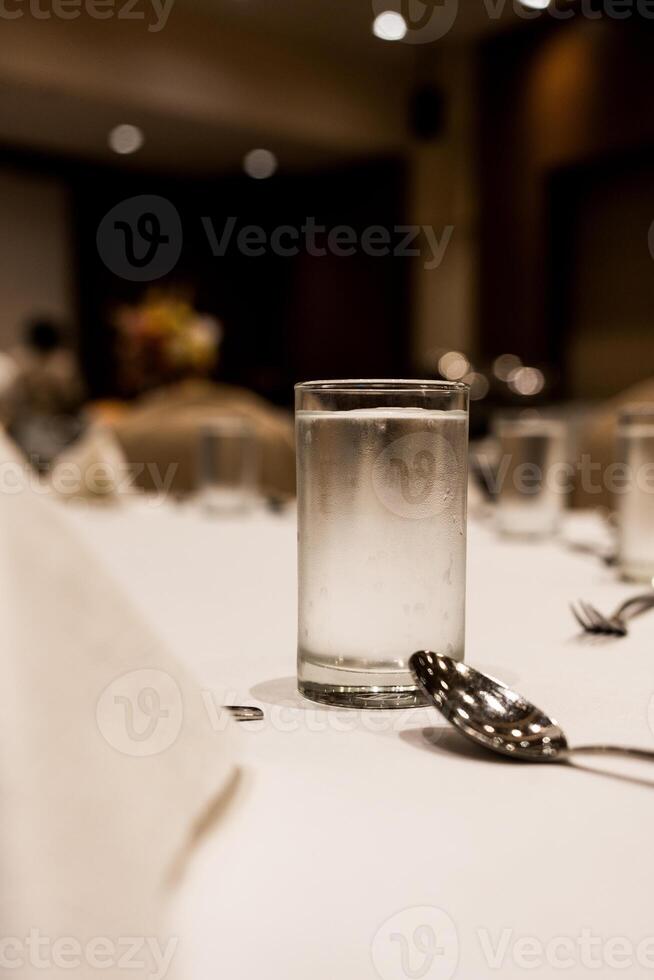 Glass of cool water on the table setting in the event photo