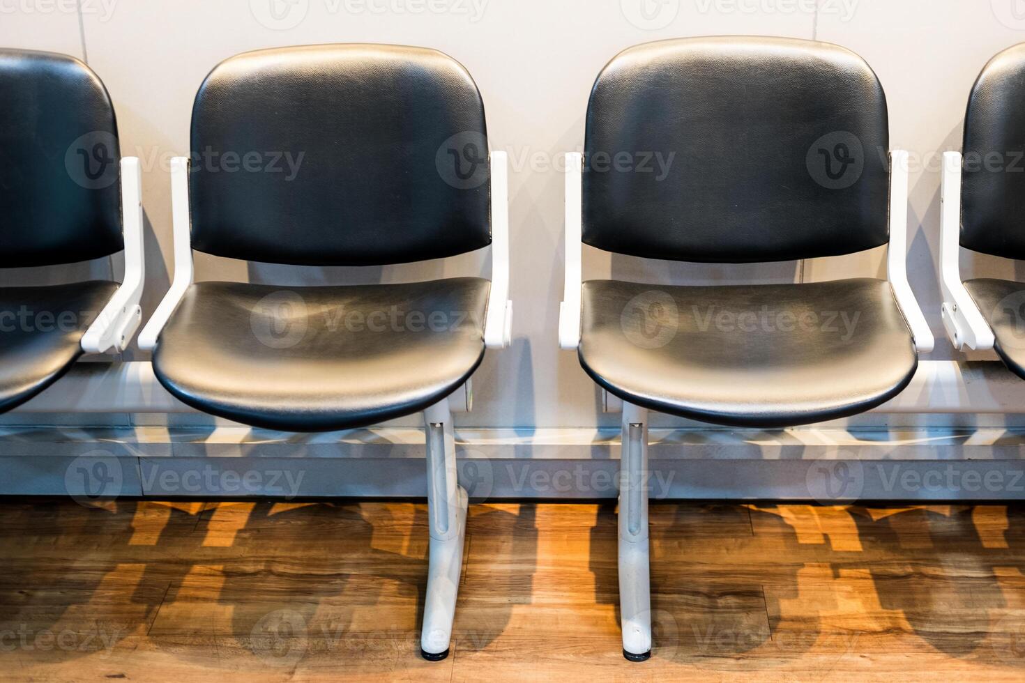 A row of chairs in a waiting room. photo