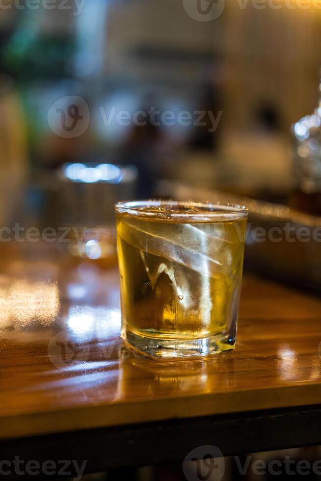 Whiskey glass with water and ice photo