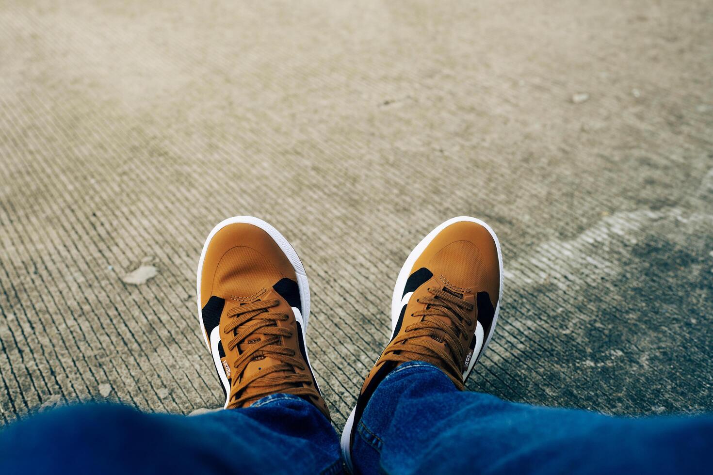Bangkok, Thailand - February 24, 2025 Young man wear sneakers Vans Mte Ultrarange Exo and sit at the street. photo