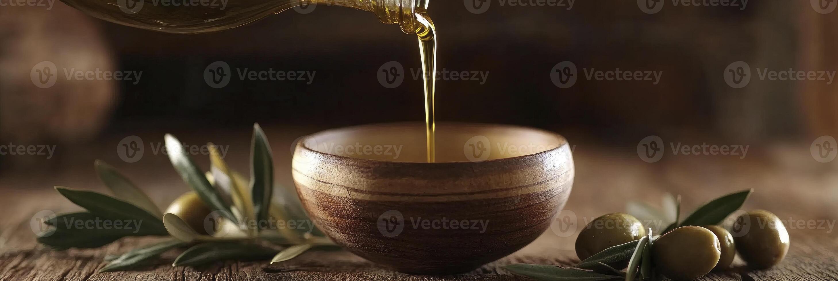 Olive oil is poured into a wooden bowl photo