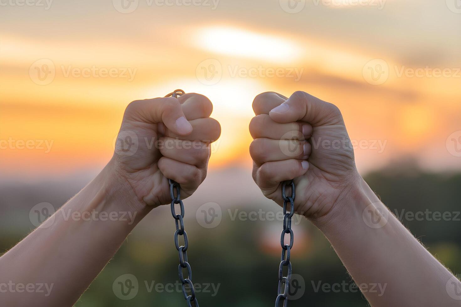Hands holding chain in sunset photo