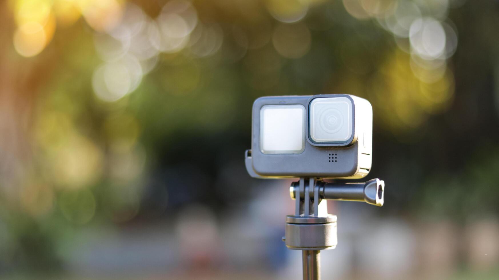 Action camera on its handle on blur background photo