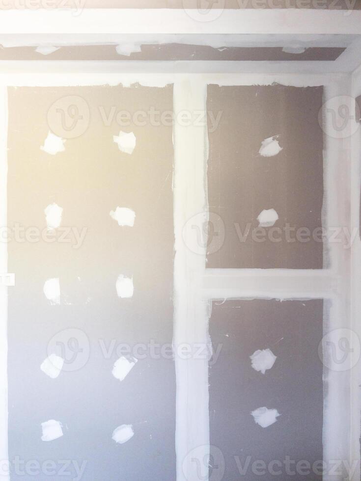Unfinished Drywall Ceiling with Joint Patching in a House Under Construction. photo