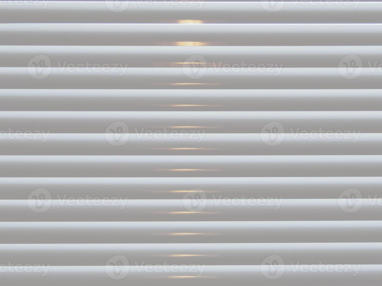 Cream Venetian blinds with light closeup abstract photo