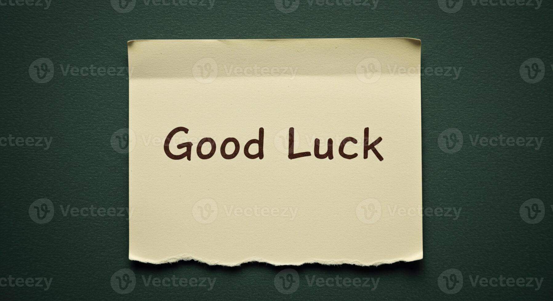 Good luck message on a piece of paper on a green background photo