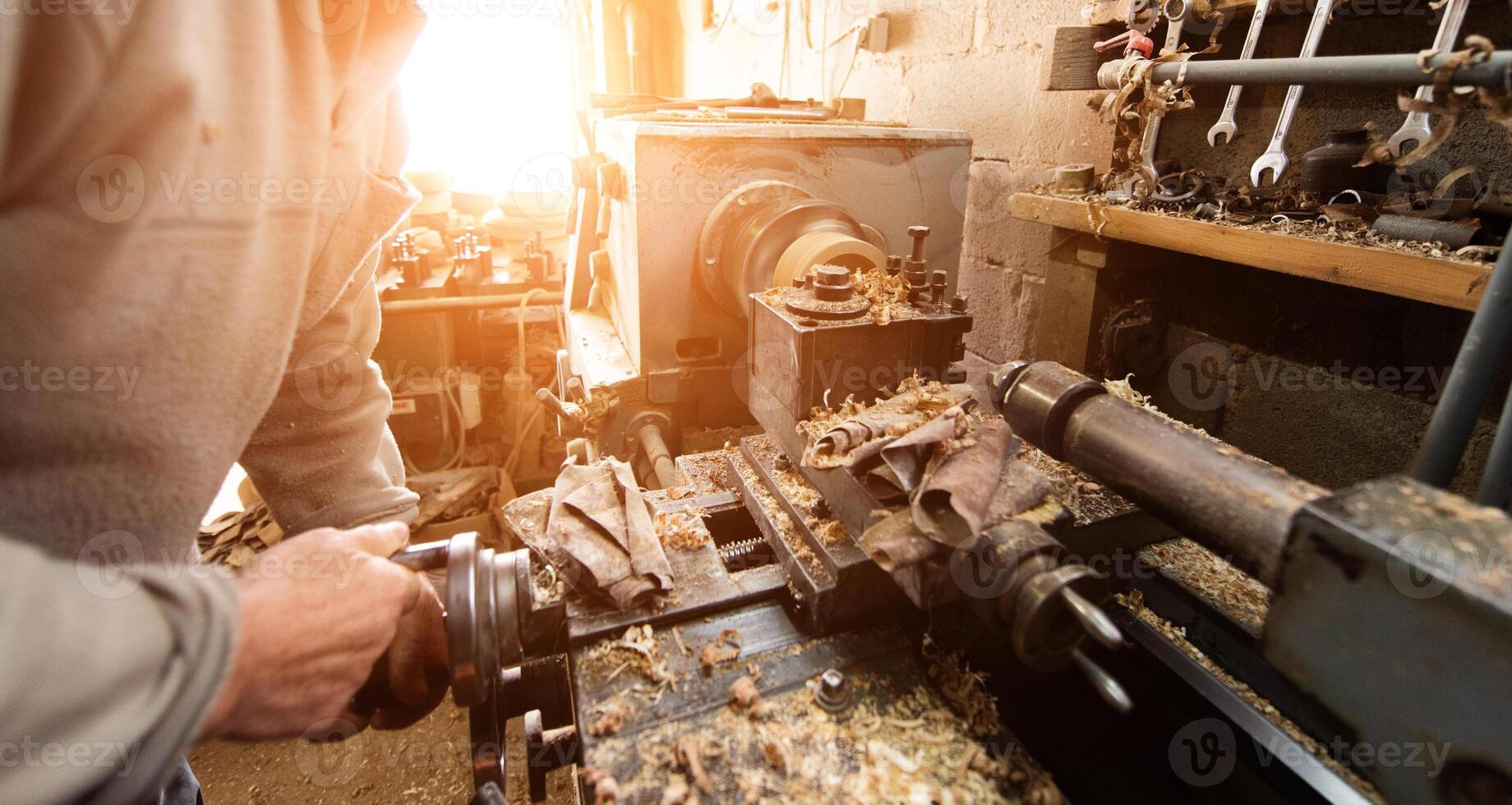 Elderly Craftsman Working in a Rustic Workshop photo