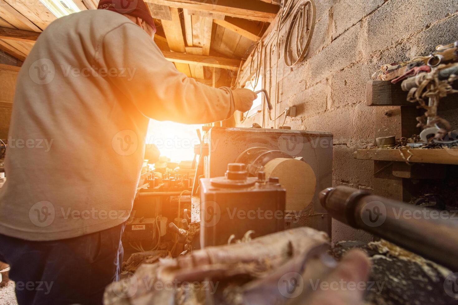 Elderly Craftsman Working in a Rustic Workshop photo