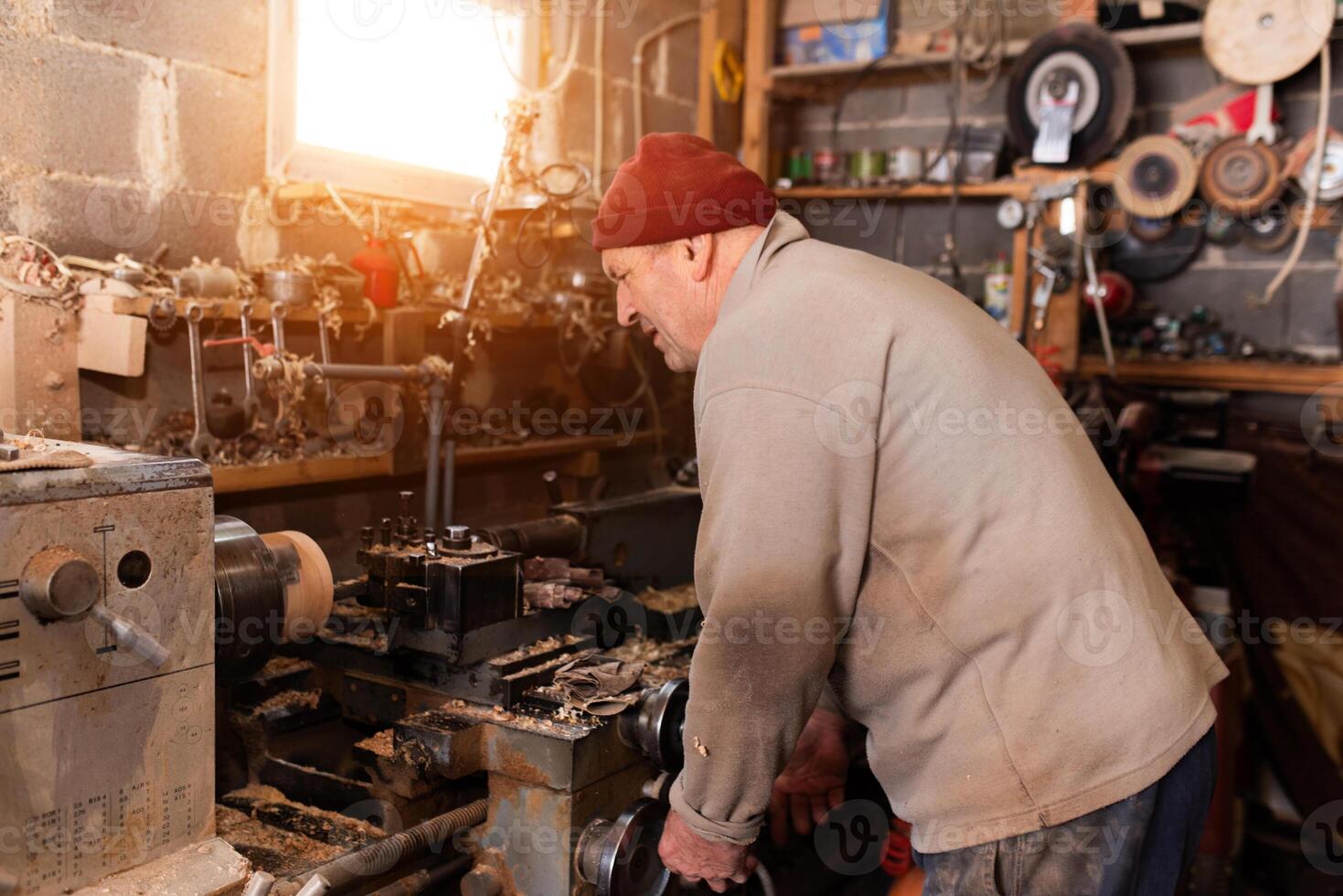Elderly Craftsman Working in a Rustic Workshop photo