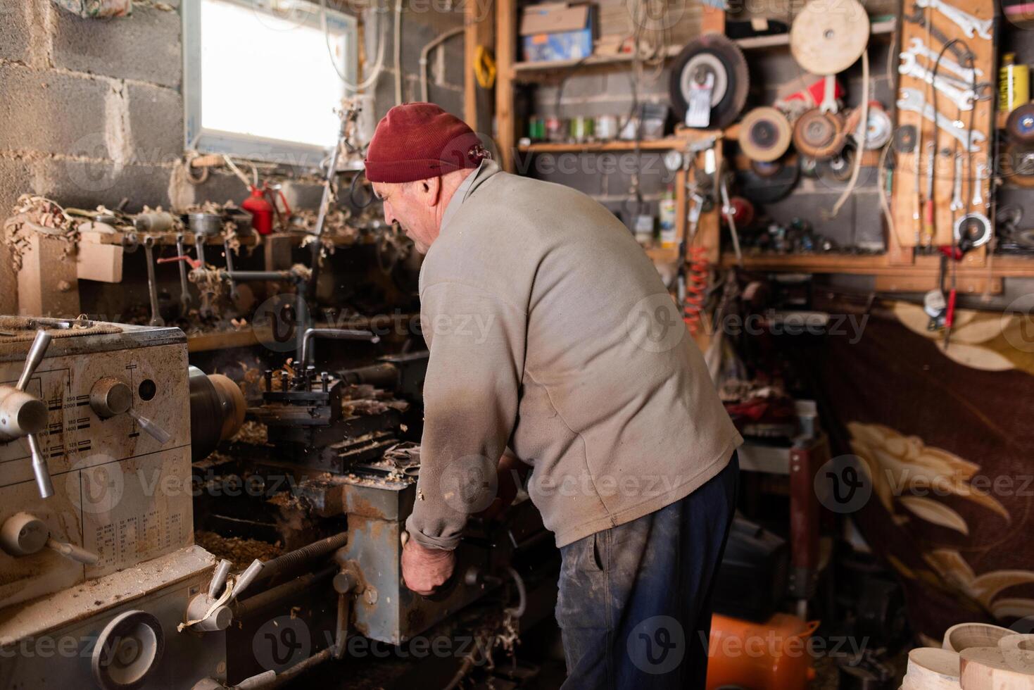 Elderly Craftsman Working in a Rustic Workshop photo