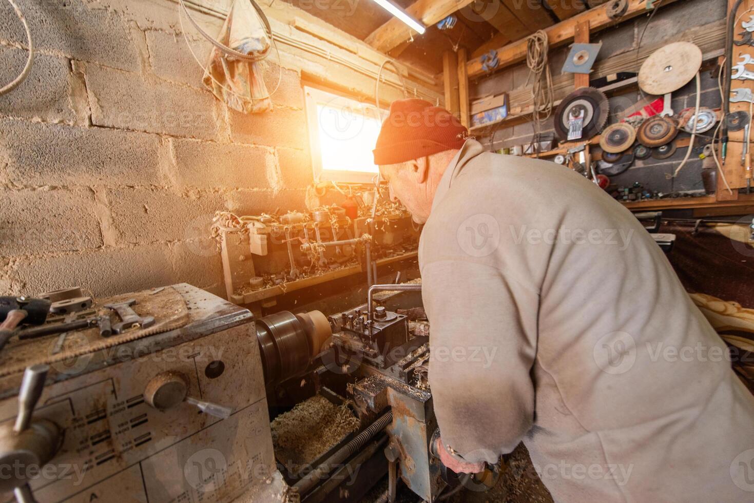 Elderly Craftsman Working in a Rustic Workshop photo
