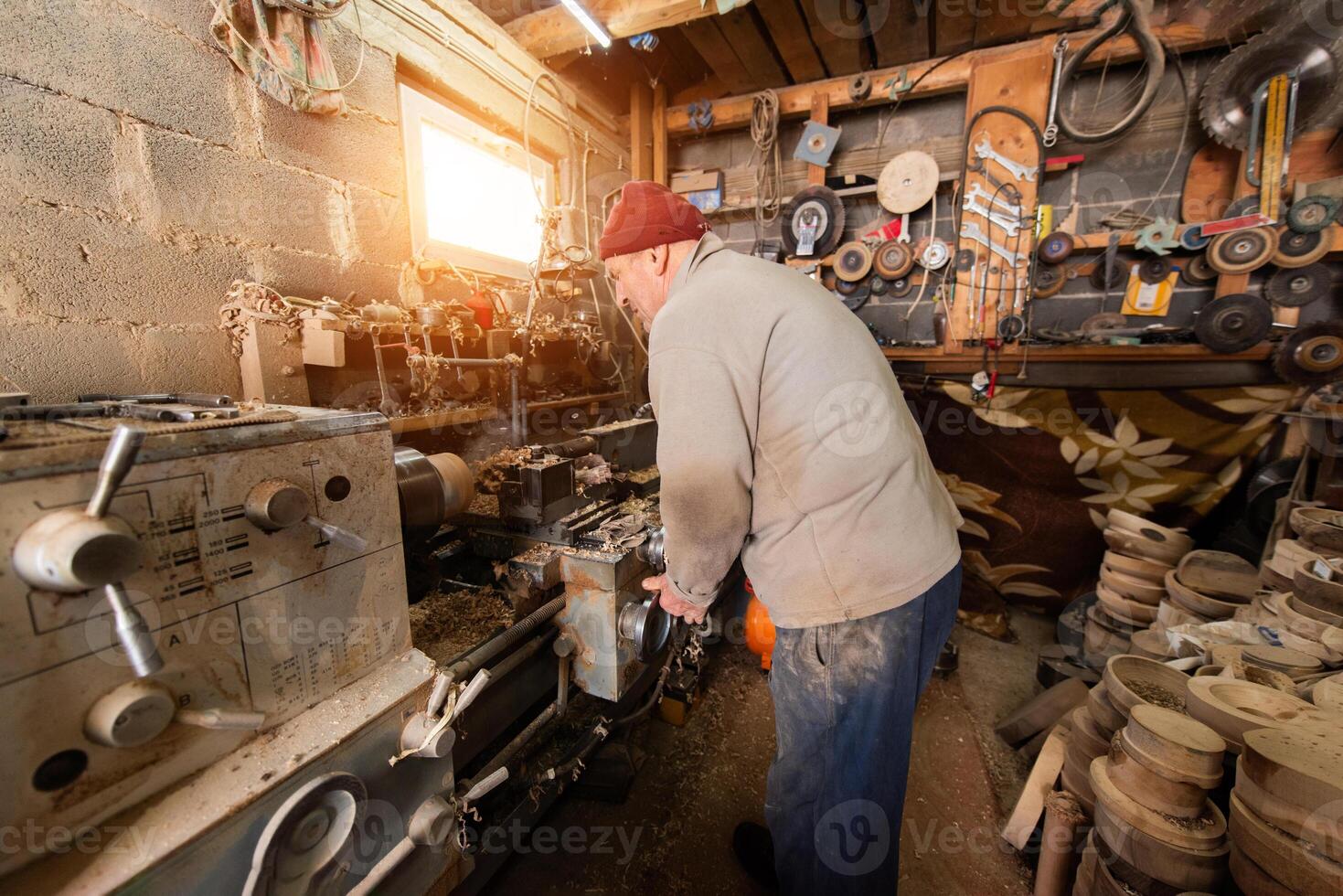 Elderly Craftsman Working in a Rustic Workshop photo