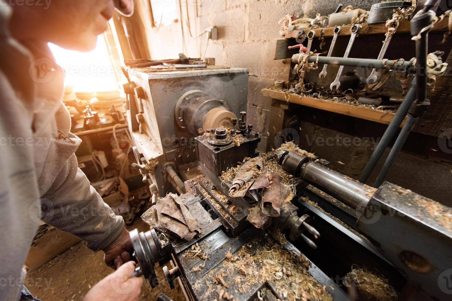 Elderly Craftsman Working in a Rustic Workshop photo