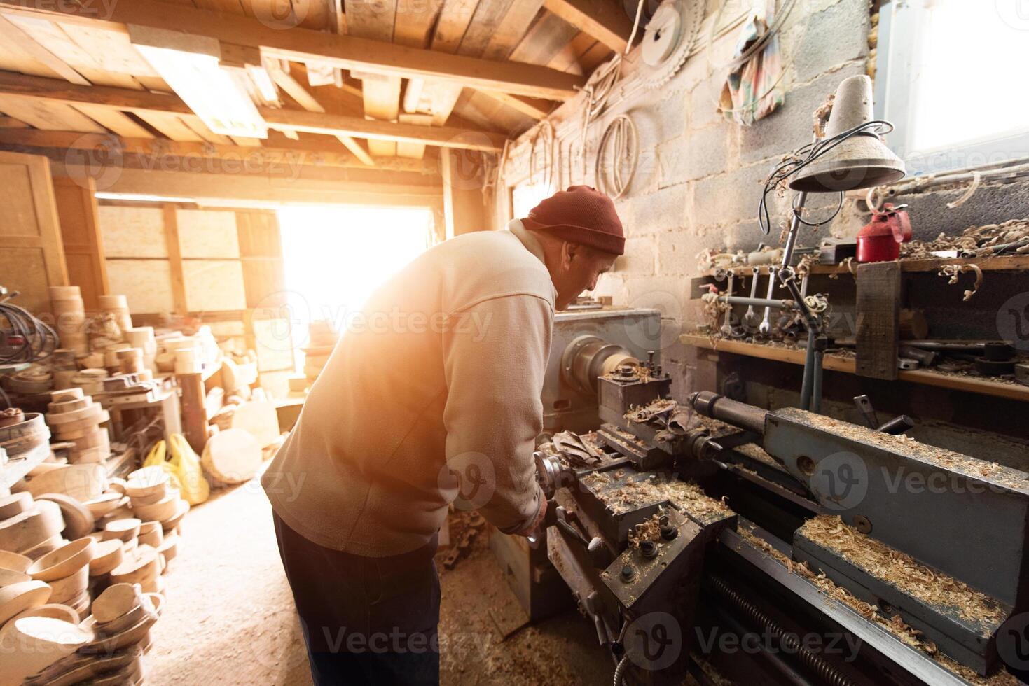 Elderly Craftsman Working in a Rustic Workshop photo