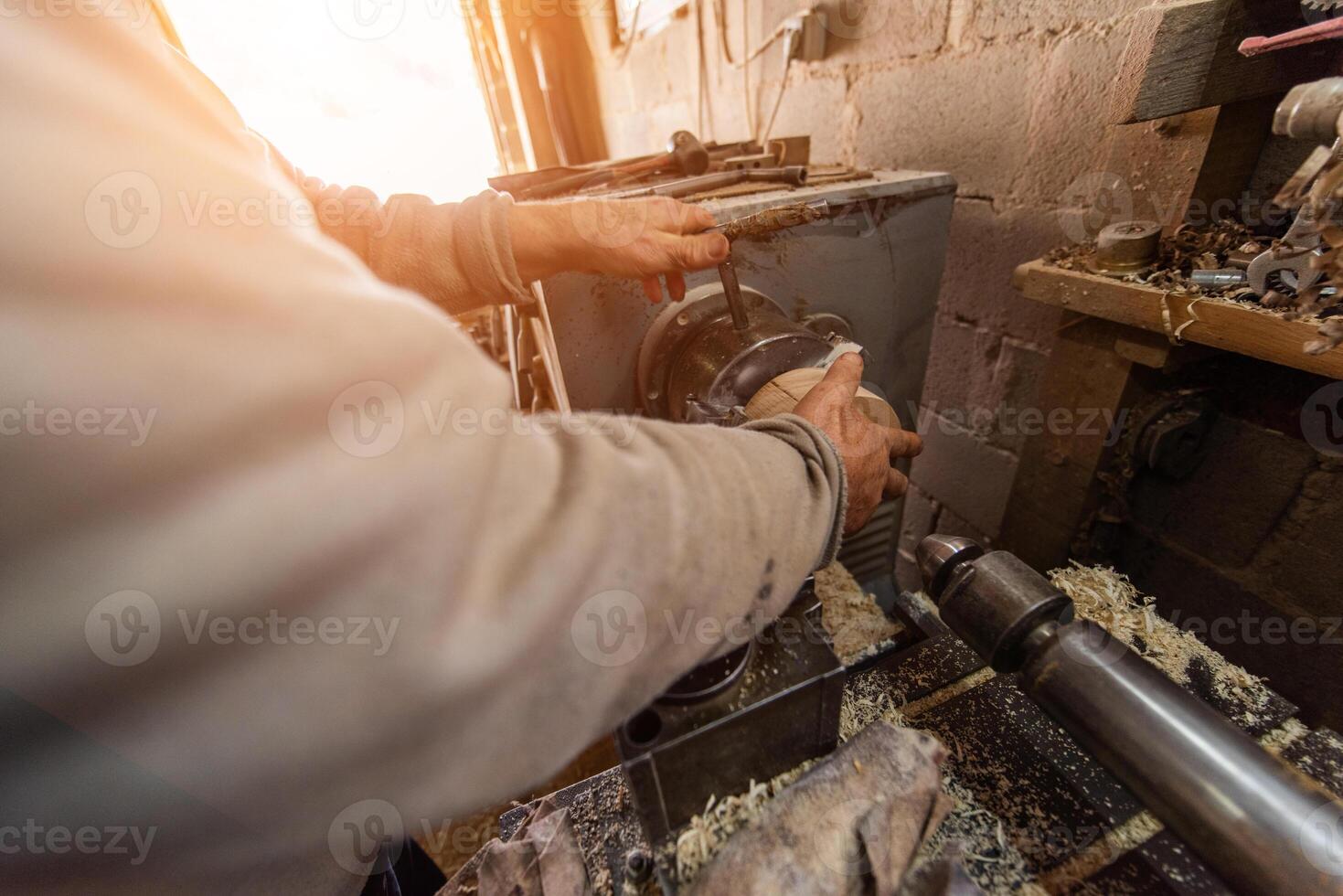 Elderly Craftsman Working in a Rustic Workshop photo