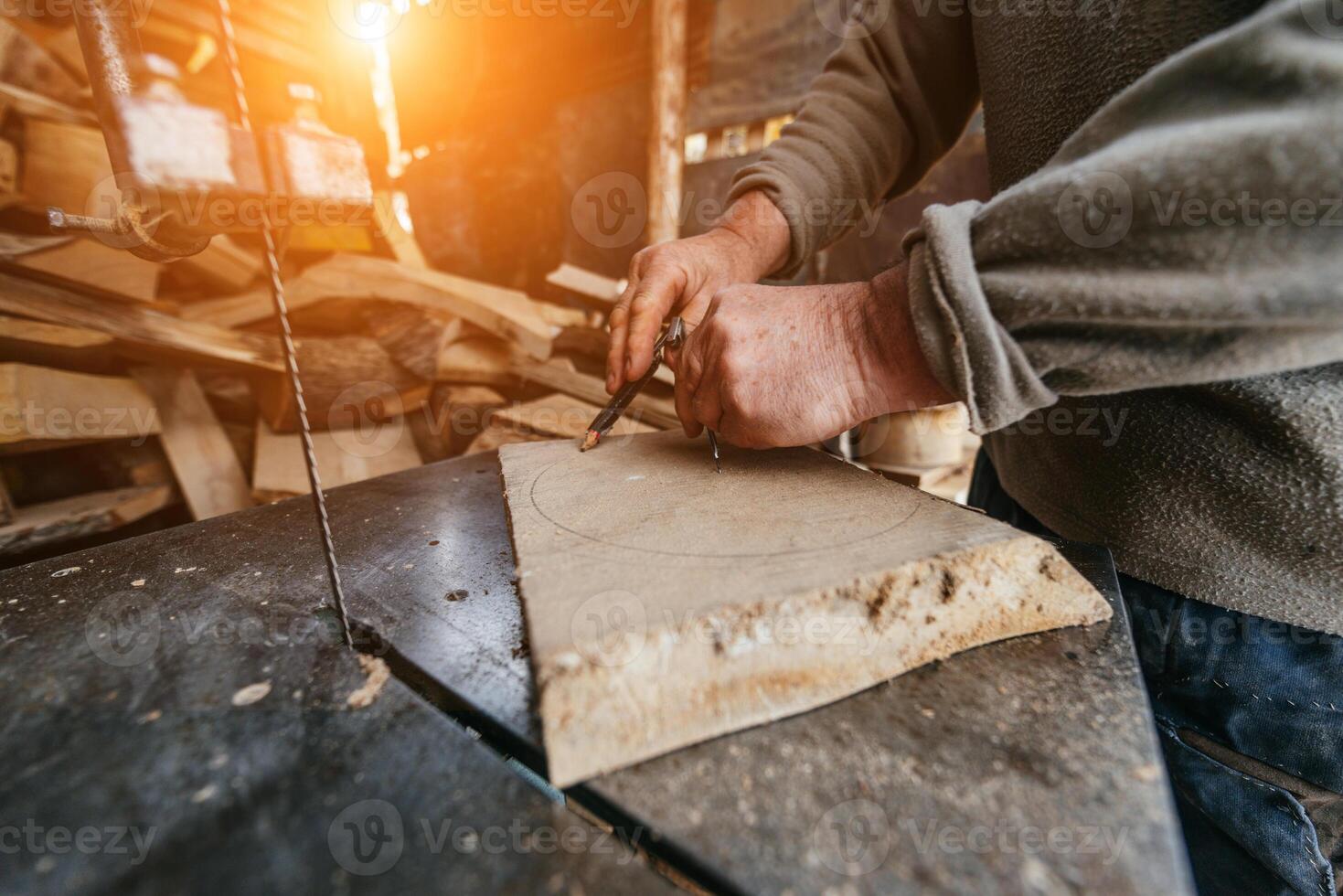 Carpenter Cutting Wood with a Bandsaw in a Rustic Workshop photo