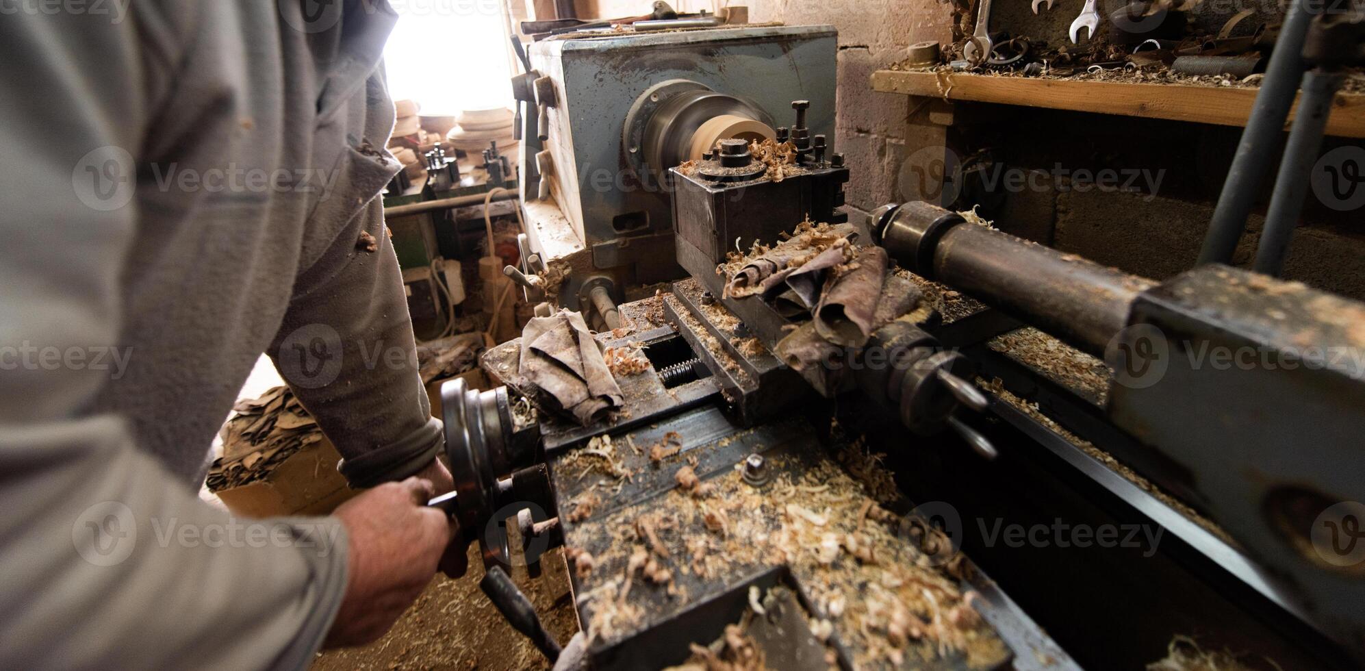 Elderly Craftsman Working in a Rustic Workshop photo