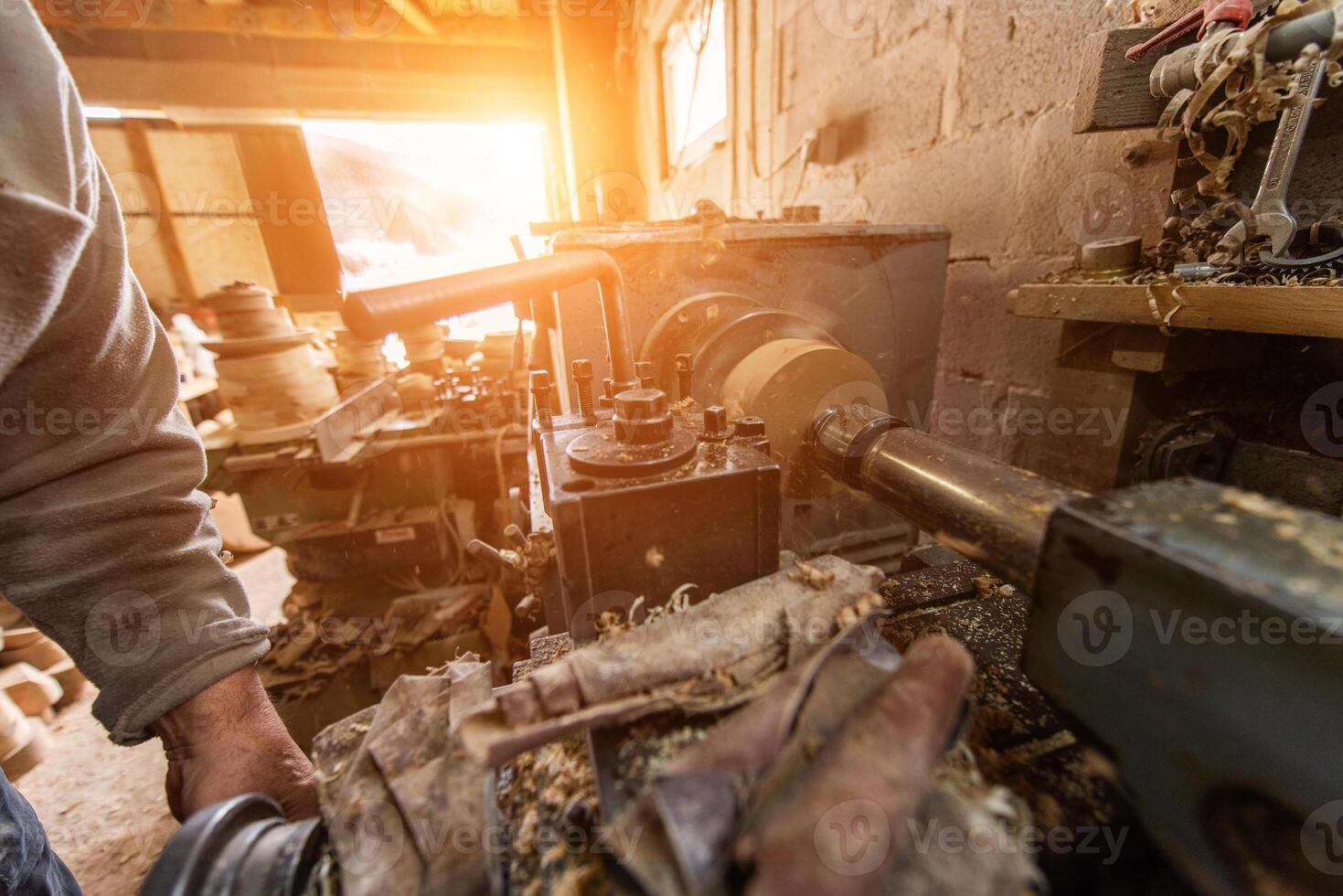 Elderly Craftsman Working in a Rustic Workshop photo
