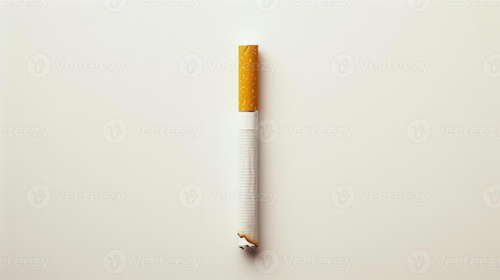 A cigarette is lit and has a red tip. photo