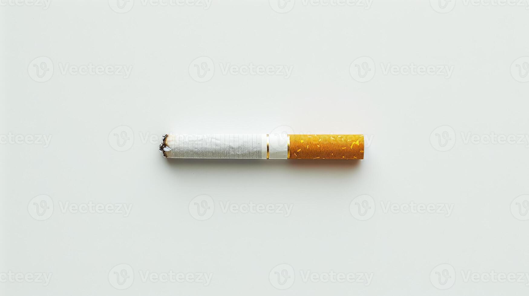 A cigarette is lit and has a red tip. photo