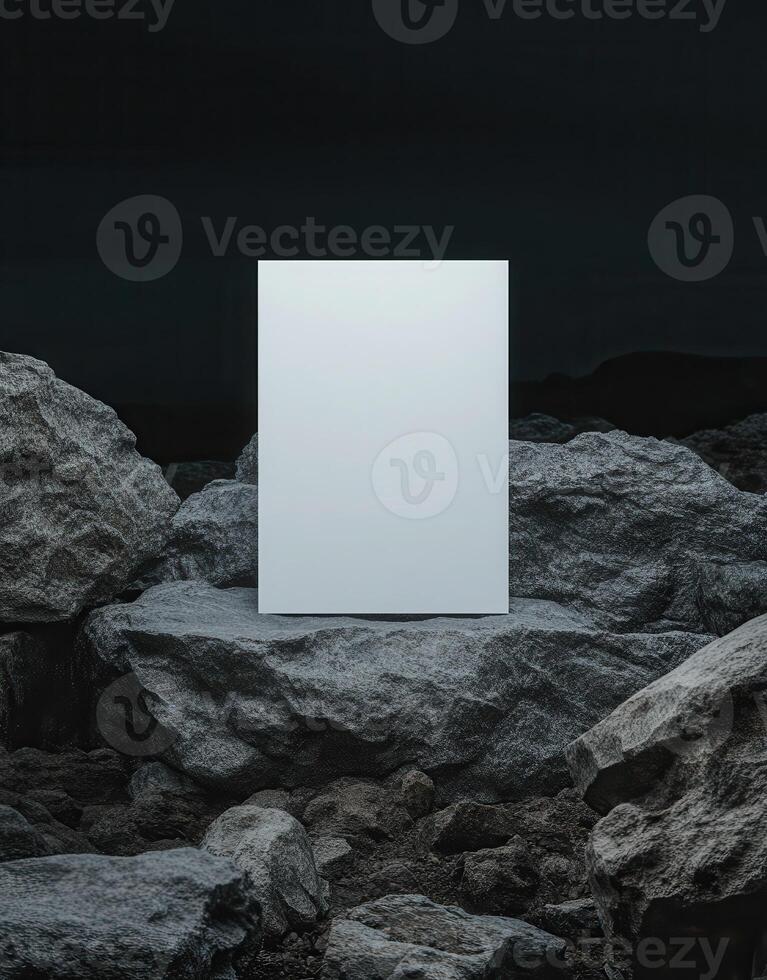 mockup of an A4 paper standing on top of rocks at night, a white blank poster, minimalistic. photo