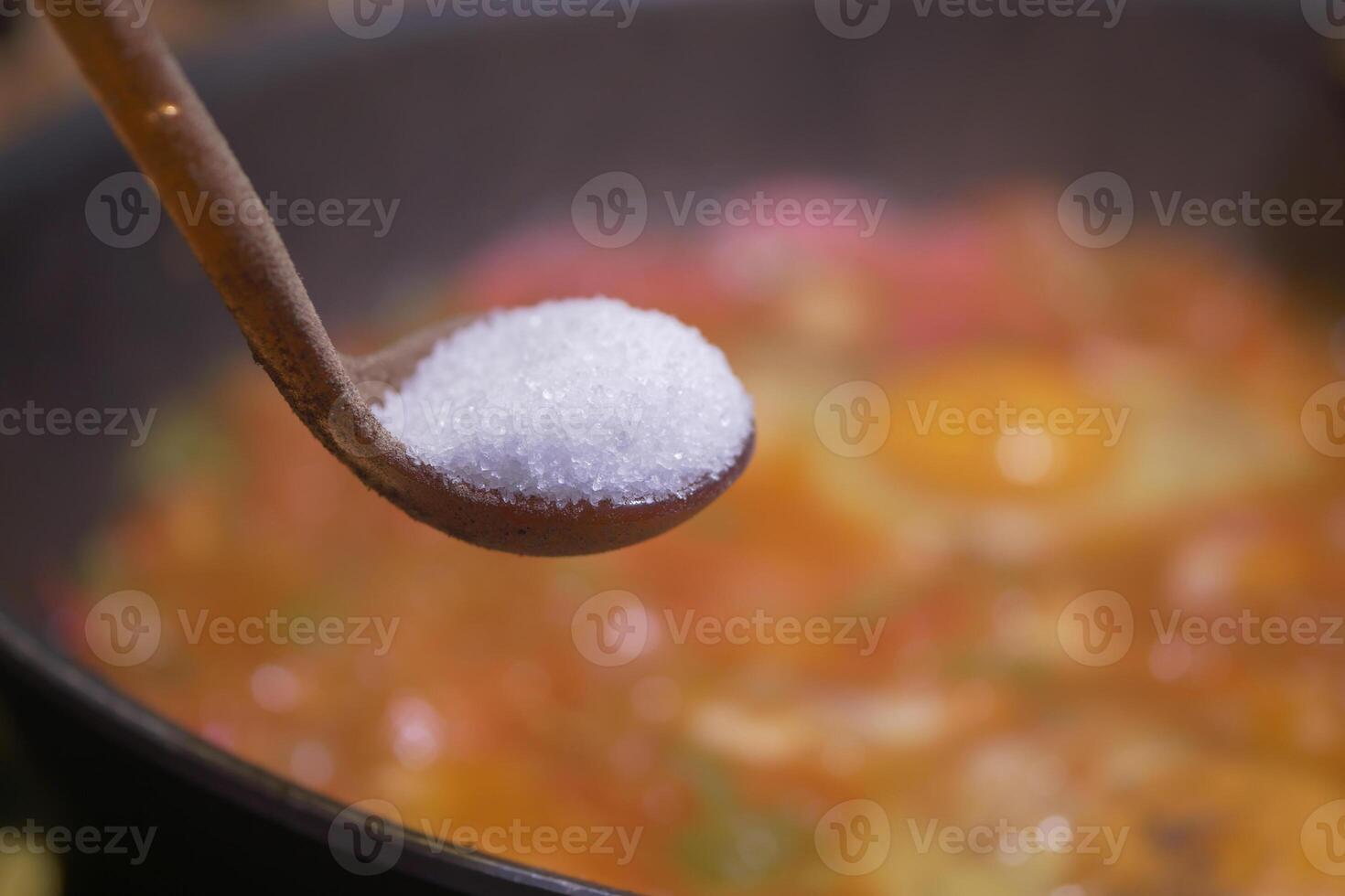 Cooking with salt to enhance flavor in a vibrant dish photo