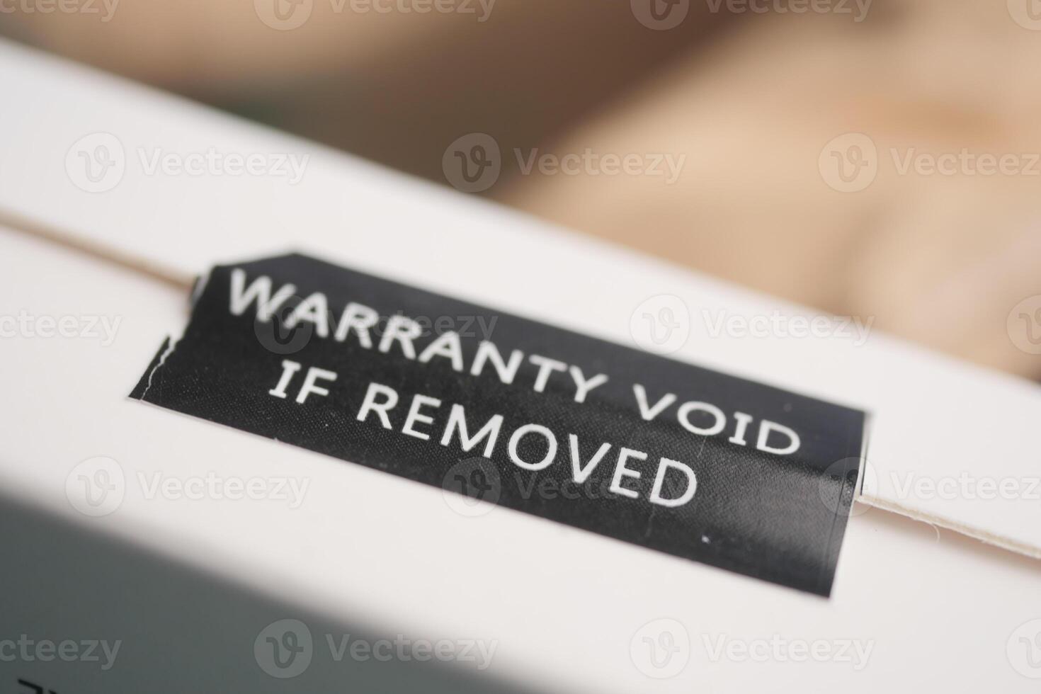 Warranty label indicating void status for removal of seal photo