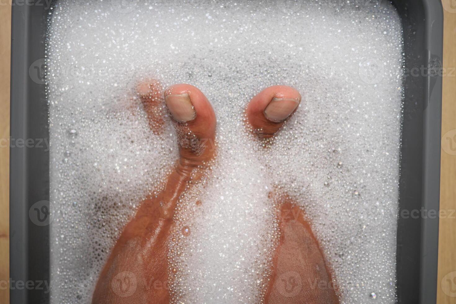 Relaxing foot soak in a bubbly bath at home for self-care photo