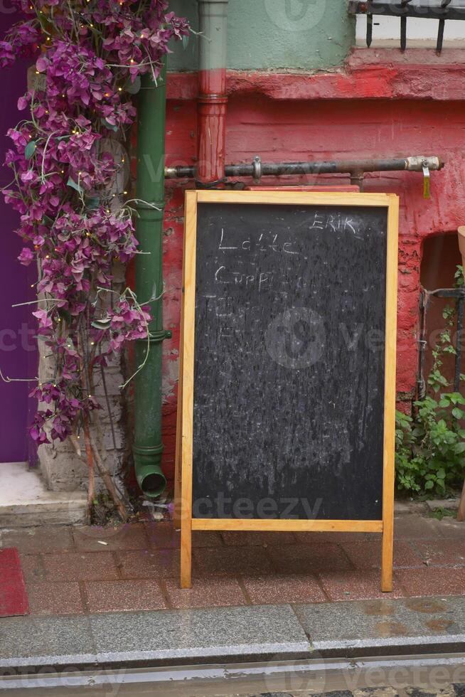 Chalkboard menu at a colorful outdoor cafe in a vibrant neighborhood photo