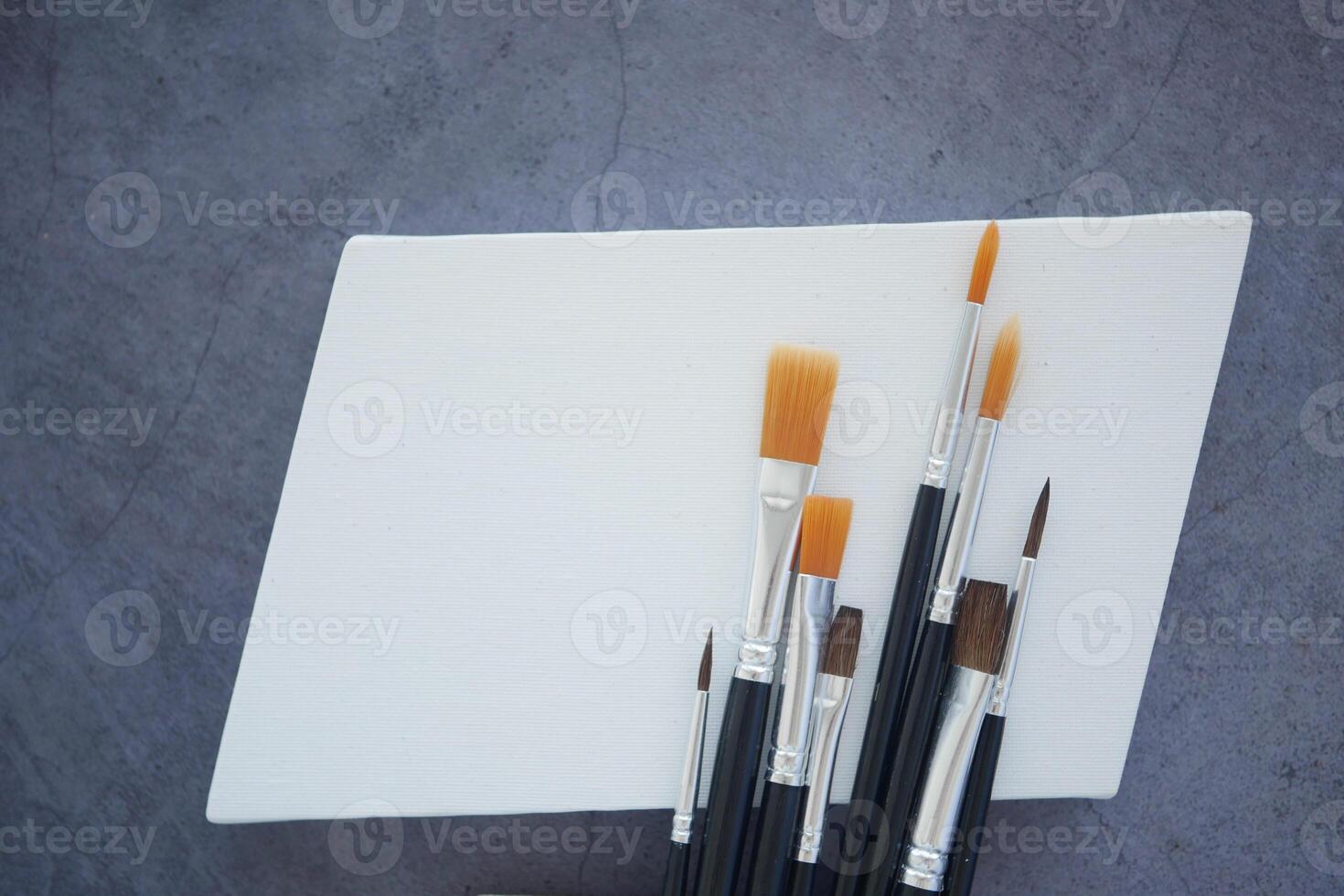 Artist tools arranged on canvas ready for creative action photo