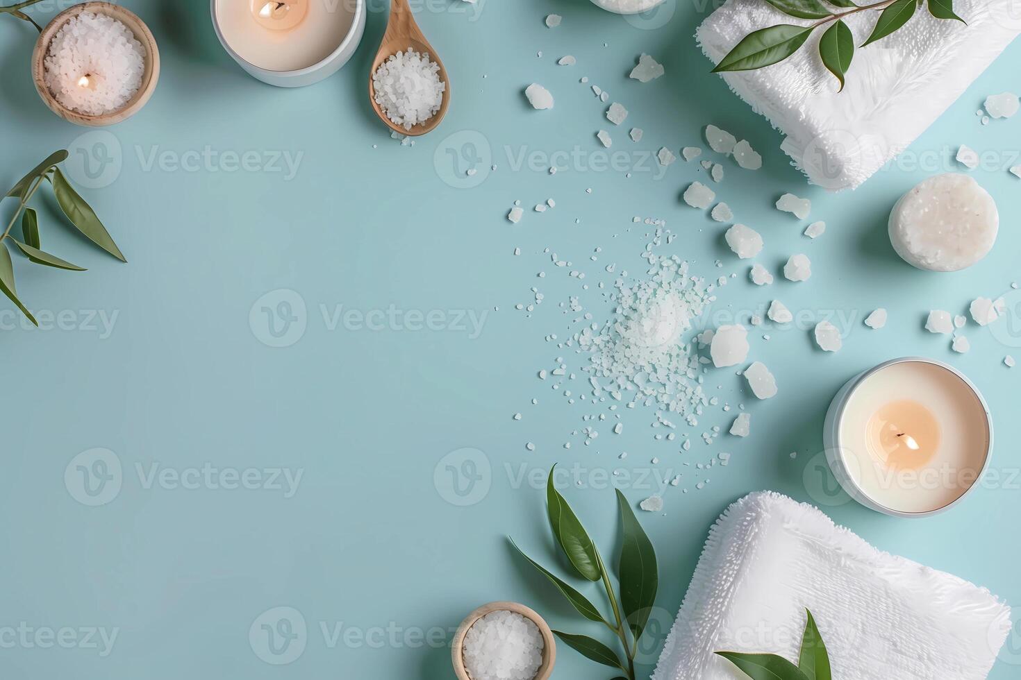 spa towels, candles and leaves on a blue background photo